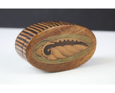 Early 19th century oval mahogany snuff box, the lid inlaid with a shell design and the sides with striped inlay, 9cm long 