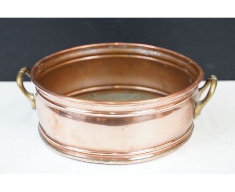Copper circular planter or plant stand with twin brass loop handles, 20cm diameter 