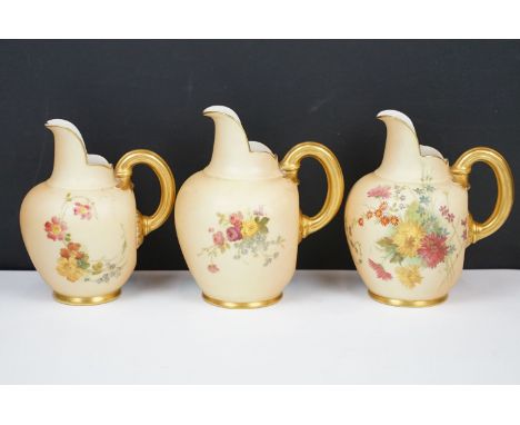 Royal Worcester 3 porcelain ivory blush flat back various size pitchers with painted sprays of flowers and gilt finishing, mo