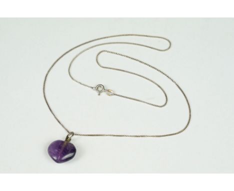 Amethyst cabochon heart shaped pendant on a silver chair 