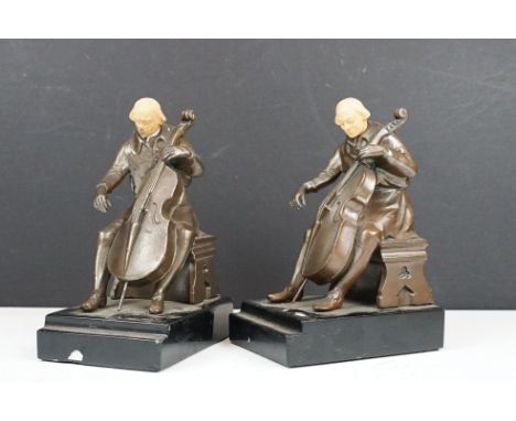 A pair of Bronze Cellist sculptured bookends By J.B. Hirsch / J Ruhl, Ivorine / Faux Ivory sculpted head and mounted to black