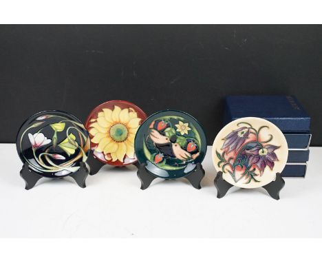 Four Moorcroft small shallow dishes: Pasque Flower, Strawberry Thief, Inca and Wood Sorrel, each 12cm diameter, each boxed an