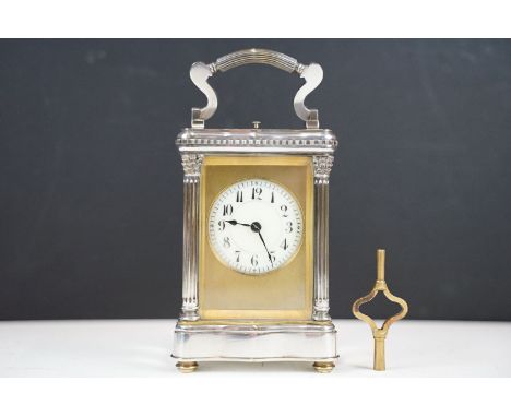 An antique French carriage clock, enamel dial, beveled glass panels. repeater movement, complete with key. 