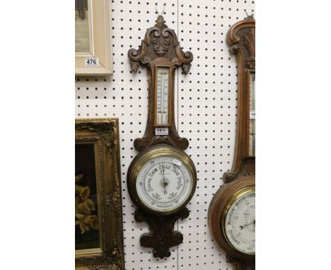 Pleasance &amp; Harper aneroid barometer in a carved oak case, with thermometer, 71cm high