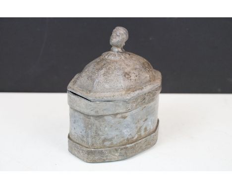 19th century lead octagonal tea caddy or tobacco jar, the lid with slave head finial opening to an inner cover, 17cm high 