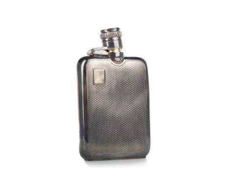 SILVER HIP FLASK, AND ANOTHER the silver flask of rectangular form and with engine turned decoration, the oval glass flask ca