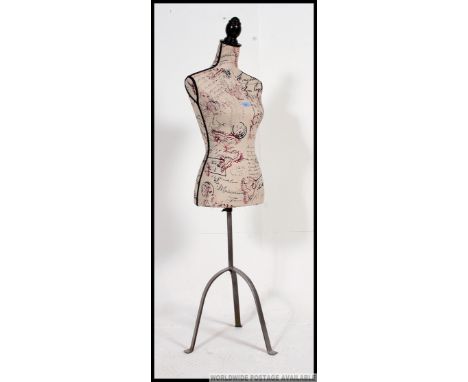 A retro style contemporary tailors dress makers shop clothing display female mannequin dummy. The material / fabric having bu