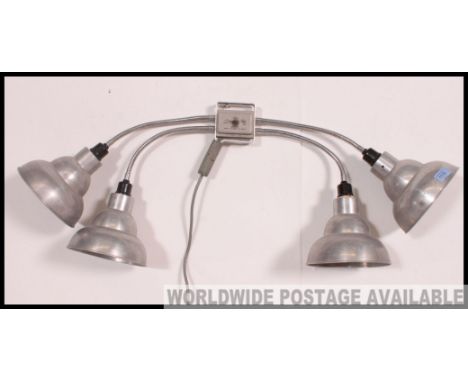 An excellent retro mid century wall mounted quadruple head anglepoise lamp. Each polished metal lampshade of pendant form on 