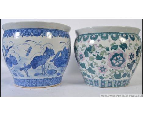 A  large Chinese blue and white ceramic carp bowls / planter with decorative designs having greek key design to top together 