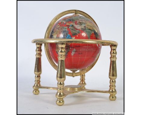 A contemporary 20th century brass mounted gemstone globe, each country made from a different type of stone.  H26cm