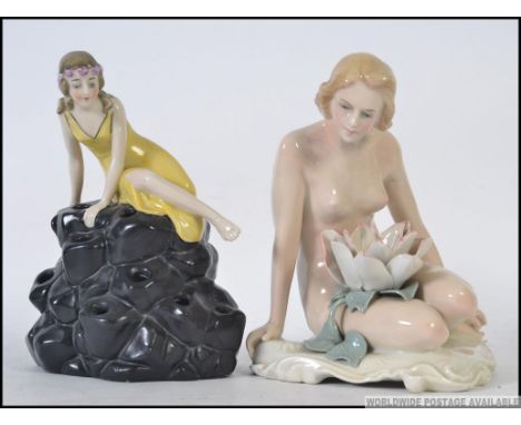 A mid 20th century Austrian ceramic figurine of a nypmh with water lily. Together with another fairy / nymph on rock base H23