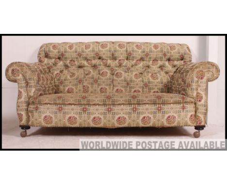 A stunning Victorian / Edwardian Chesterfield style button back sofa, still retaining original material, raised on later cast