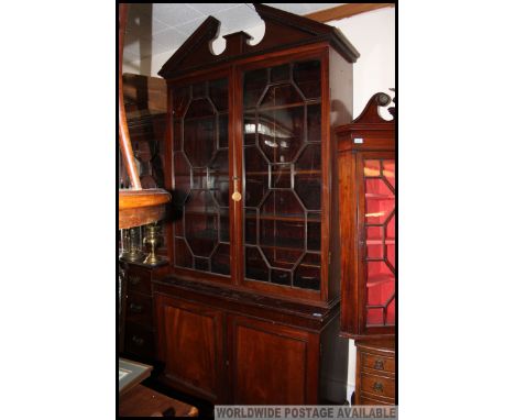 A 19th century Gerorgian library bookcase cabinet / cupboard. The plinth base with double door fielded panel cupboard. Above 