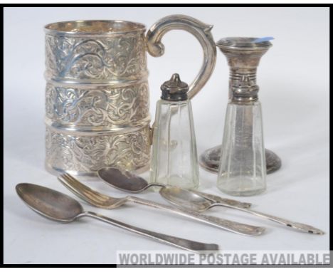 A collection of flatware to include a Silver hallmarked candle stick, along with a good quality tankard, cruets, flatware etc