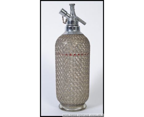 A vintage 20th English made French / Czech influence  soda syphon with metal / wirework covered glass body. 35cm