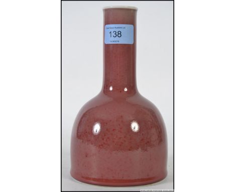 A Chinese monochrome ochre red vase of onion form with flat base having blue character marks to the base H20cm