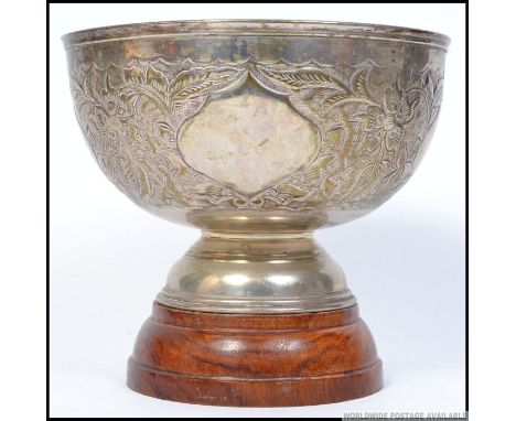A vintage silver plate award trophy not being engraved to the armorial cartouche being raised on original circular wooden bas