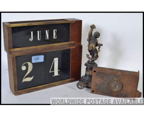 A collection of vintage date cards from a wooden desk clock together with a vintage 19th century lock and a cold cast cherub 