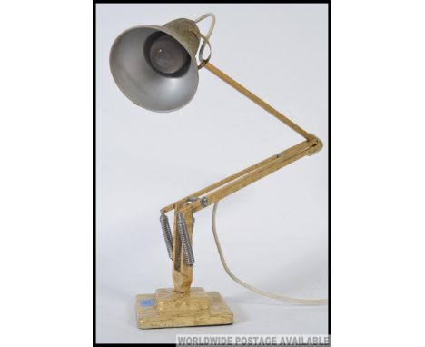 A vintage original Herbert Terry angle poise lamp with a two step base.  Cream and gold fleck in colour.