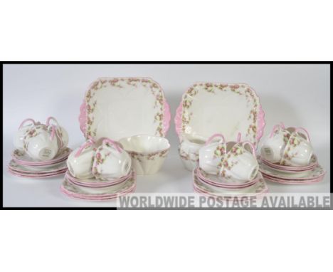 An early 20th century Shelley part tea service in a chintz floral pattern to include cups, saucers, plates etc