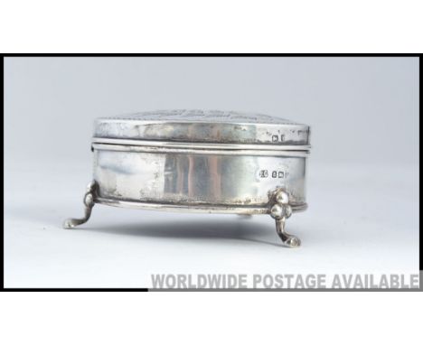 A silver trinket box on hoof feet with Birmingham hallmarks 1908 makers Joseph Gloster. Decorated with ferns having central m