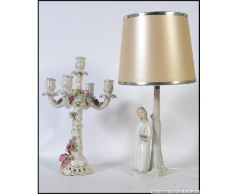 A Lladro porcelain figurine lamp of a girl in nightgown with candlestick together with a Dresden porcelain 5 branch candlesti