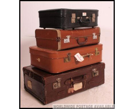 A vintage 20th century stack of vintage suitcases to include varying sizes, colours etc, leather / vinyl etc