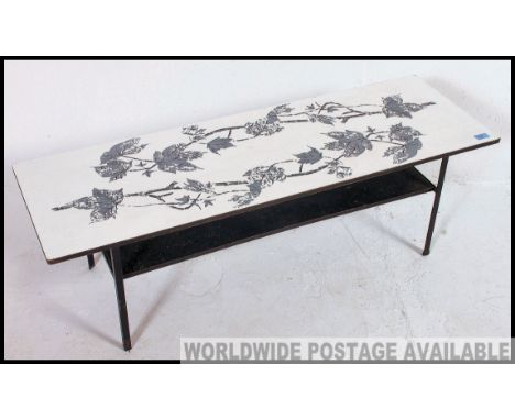 A retro 1970's  melamine topped coffee table, raised on a tubular metal frame united by an under tier shelf Reminiscent of th