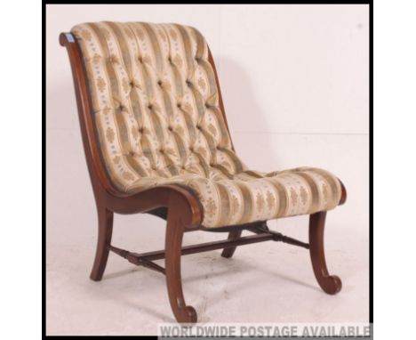 An early  20th century open frame nursing chair, with shaped legs united by turned stretcher having button back detail on a v