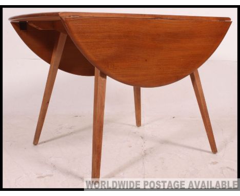 Retro / Vintage 1960's circular drop leaf Golden Dawn dining table by Ercol.  Measures: 73 x 113.