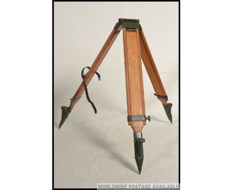 A good mid century wooden and enamelled metal tripod stand of chunky heavy construction ideal as a conversation for a standar