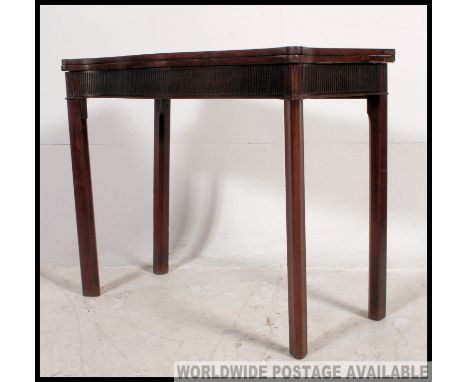 A 19th century mahogany serpentine fronted games / card / tea  table raised on squared legs with flip over games table top su