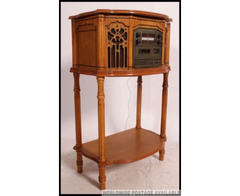 A vintage style oak cased cd player - hi fi system. The case raised on turned legs