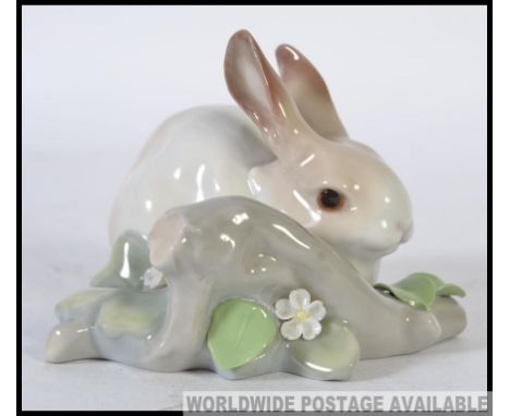 A Lladro ceramic  Figure group of a Rabbit in a naturalistic setting by a Branch W11cm
