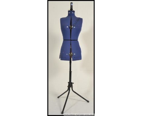 A vintage / retro dress makers / tailors mannequin dummy. Fully adjustable, on an adjustable metal base raised on tripod feet