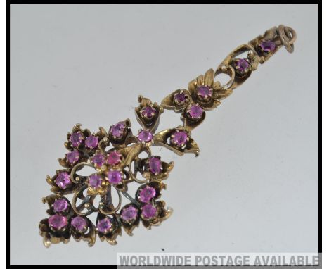 A stunning ladies ruby on gilt silver necklace pendant in the form of a floral spray bouquet. Total weight 8.5g