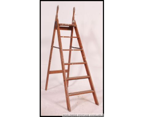 A vintage mid century folding painters wooden ladder having handles to top in good condition
