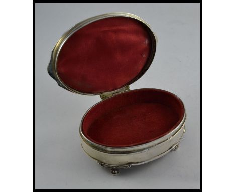 A silver hallmarked ladies jewellery trinket box raised on decorative feet having hinged top and lined interior. Birmingham h