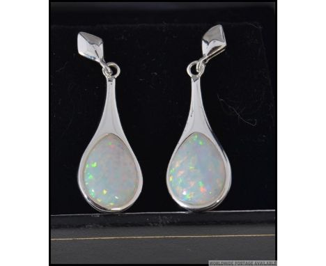 A pair of silver CZ and opal earrings