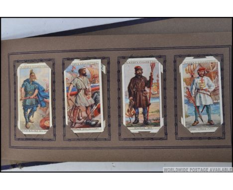 A vintage cigarette card album ' Cigarette Picture Album ' containing several cards - Players Poultry, Dogs, and History Of N