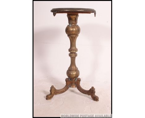 A 19th century gilt brass and rouge marble tripod table. The rococo brass tripod base having circular rouge marble top above