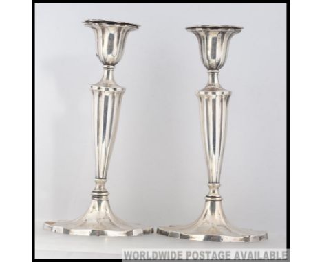 A pair of antique William Hutton & Sons hallmarked silver candlesticks, with splayed bases and ribbed fluted stems, with remo