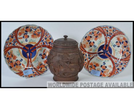 A near pair of Japanese 19th / 20th century Imari plates along with a carved wooden Chinese tea caddy ornately carved in reli