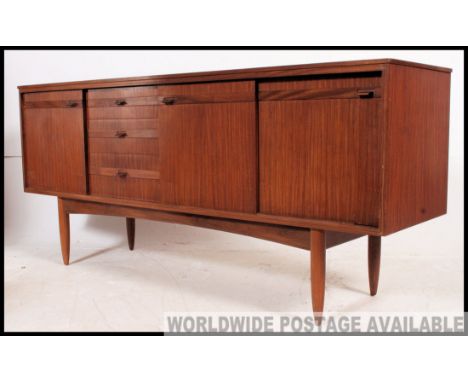 Retro / vintage Danish style teak sideboard circa 1960's, having a run of tree drawers flanked by a pair of inset sliding doo