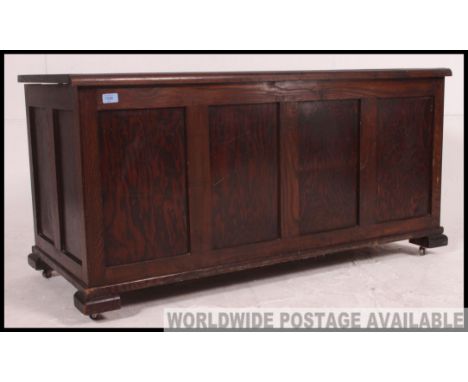 A large late Victorian oak coffer chest / blanket box. Raised on bracket feet with fielded panel body with hinged top above  