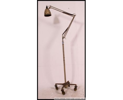 An original early 20th century floorstanding Herbert Terry anglepoise lamp. Original finish with yellow castor wheels and the