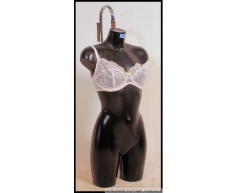 A retro 20th century half mannequin shop torso / tailers dummy of black plastic / resin form. Measures: 85 x 40 x 20.