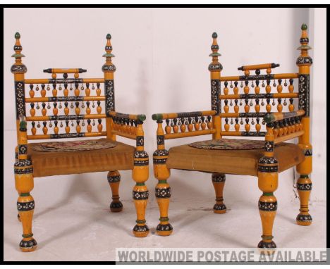 A stunning pair of Indian handpainted yellow opium / hall chairs raised on turned legs with overstuffed velour needlepoint se