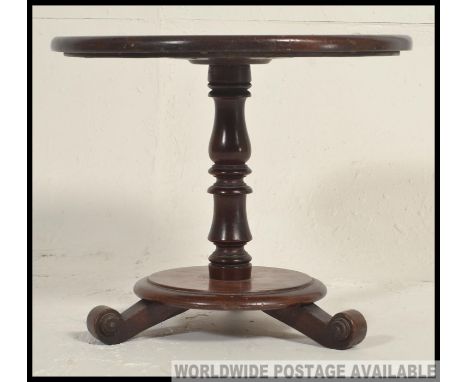 An late 19th / early 20th century Victorian / Edwardian mahogany circular occasional pedestal table, raised on a turned suppo