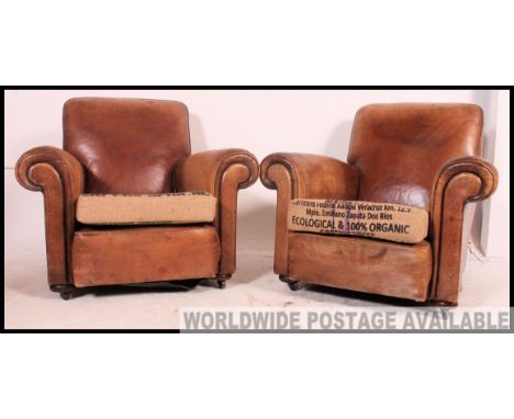A fantastic pair of 1930's vintage leather club arm chairs, both chairs having a unique Hessian sack cushion pads Measures: 8